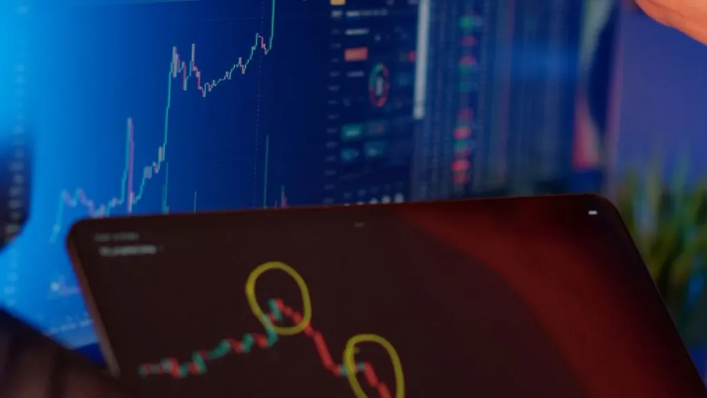 Person analyzing cryptocurrency market trends on multiple screens