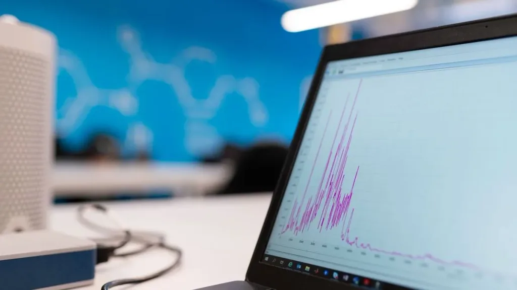 Laptop screen showing cryptocurrency market data and graphs