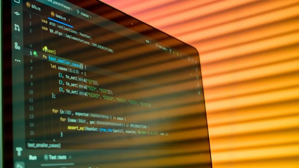 Close-up of a computer screen displaying code on a monitor